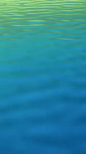 A Blue And Green Water With Ripples Wallpaper