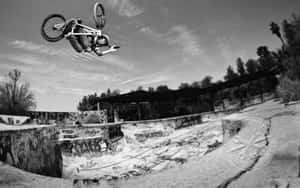 A Bmx Rider Flying Off A Half-pipe Ramp Wallpaper