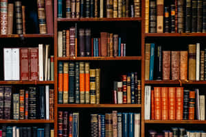 A Book Shelf With Many Books On It Wallpaper