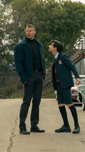 A Boy And A Girl Standing Next To Each Other Wallpaper