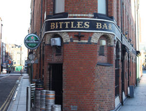 A Brick Building With A Sign Wallpaper