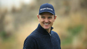 A Cheerful Justin Rose On The Golf Course Wallpaper