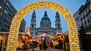A Christmas Market With Lights In Front Of A Church Wallpaper