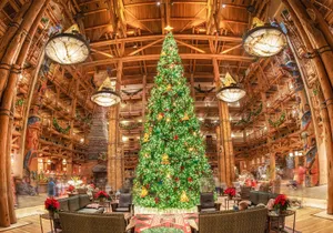 A Christmas Tree In The Lobby Of A Hotel Wallpaper