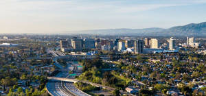 A City With A Highway And Trees In The Background Wallpaper