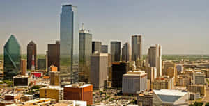 A City With Tall Buildings And A Lot Of Cars Wallpaper