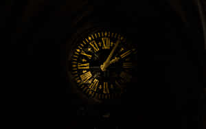 A Clock In A Dark Building Wallpaper