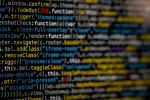 A Close Up Of A Computer Screen With A Lot Of Code Wallpaper