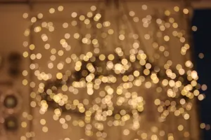 A Cozy Christmas Tree Surrounded By A Warm Glow Of Lights To Bring Holiday Cheer. Wallpaper