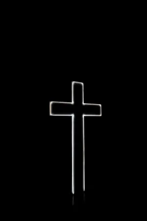 A Cross Is Lit Up In The Dark Wallpaper