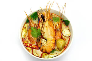 A Delicious Bowl Of Tom Yum Soup With Big Prawns Wallpaper