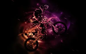 A Dirt Bike Rider Is Flying Through The Air Wallpaper