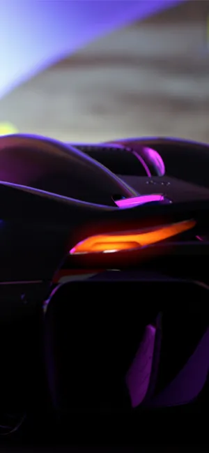 A Futuristic Car With A Bright Light Shining On It Wallpaper