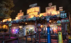 A Gas Station With Many Signs And Lights Wallpaper