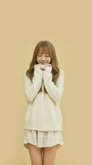 A Girl In A White Sweater And Skirt Posing Wallpaper