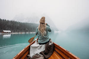 A Girl Riding A Boat On Water Lake Wallpaper