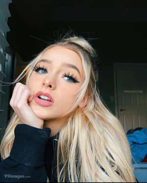 A Girl With Long Blonde Hair And Blue Eyes Wallpaper