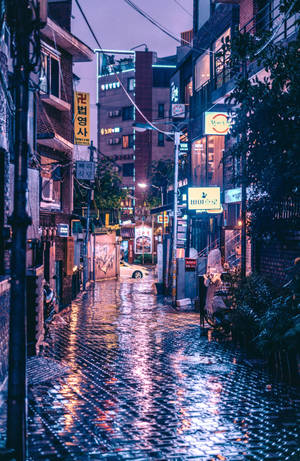 A Glimpse Of Serenity: Korean Aesthetic In A Wet Street Scene Wallpaper