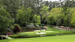 A Golf Course With A Pond And Trees Wallpaper