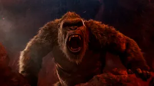 A Gorilla Is Standing In The Middle Of A Rocky Area Wallpaper