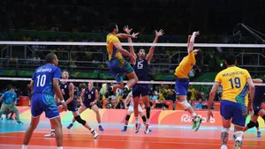 A Group Of Men Playing Volleyball In A Game Wallpaper