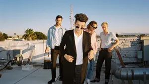 A Group Of Men Standing On A Roof Wallpaper