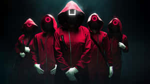 A Group Of People In Red Hoodies Standing In Front Of A Dark Background Wallpaper