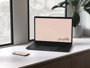 A Laptop And Phone On A Desk Next To A Window Wallpaper