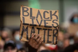 A Large Crowd Protesting Against Systemic Racism And Inequality Wallpaper