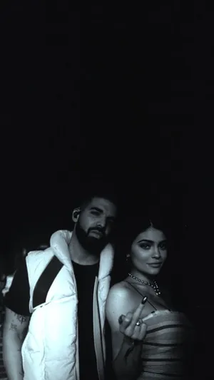 A Man And Woman Standing Next To Each Other Wallpaper