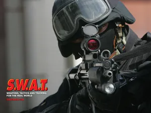 A Man In A Black Uniform With A Gun Wallpaper