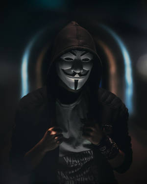 A Man In A Hoodie And Mask Is Standing In A Tunnel Wallpaper