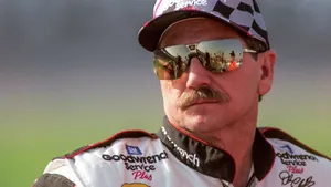 A Man In A Nascar Uniform With Sunglasses Wallpaper
