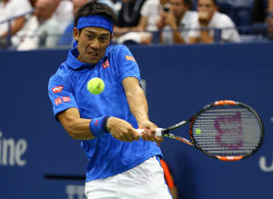 A Man Is Playing Tennis With A Racquet Wallpaper