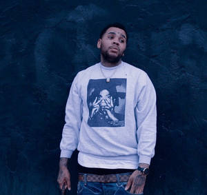 A Man Wearing A Grey Sweatshirt With A Picture Of A Man Wallpaper