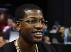 A Man Wearing Glasses And A Necklace Wallpaper