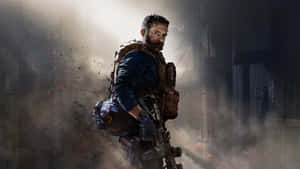 A Man With A Rifle Is Standing In A Dark Room Wallpaper