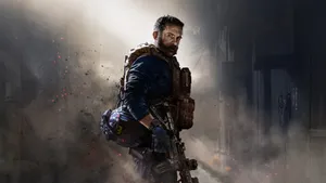 A Man With A Rifle Is Standing In A Dark Room Wallpaper