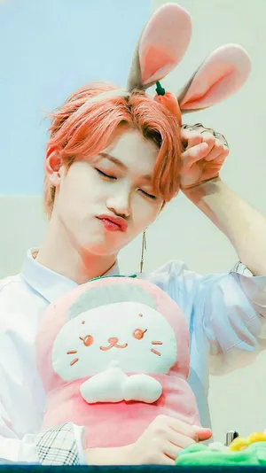 A Man With Pink Hair Holding A Pink Bunny Stuffed Animal Wallpaper