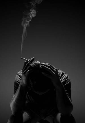 A Mischievous Man Leaning On Wall Wallpaper