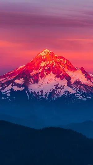 A Mountain Is Seen At Sunset With A Colorful Sky Wallpaper