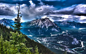 A Mountain Range With Trees Wallpaper