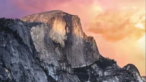 A Mountain With A Colorful Sunset Behind It Wallpaper