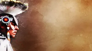 A Native American Man In A Feathered Headdress Wallpaper