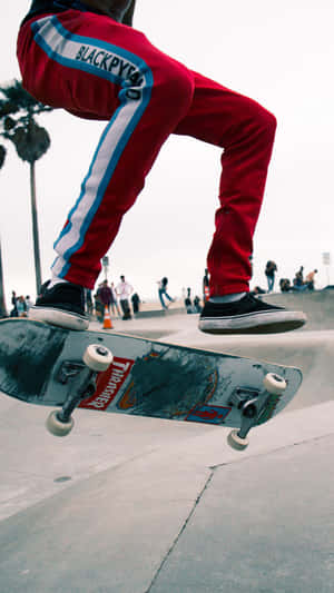 A Person Doing A Trick On A Skateboard Wallpaper