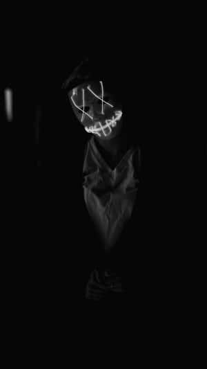 A Person In A Dark Room With A Light On His Face Wallpaper