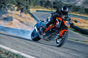 A Person Riding A Ktm Duke 200 Wallpaper