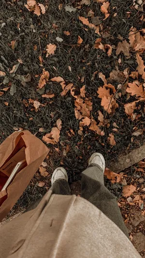 A Person Standing On A Grassy Area With A Bag Wallpaper
