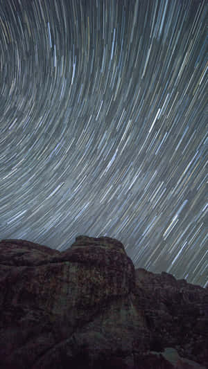 A Picturesque Time Lapse Of Clouds And Stars Wallpaper