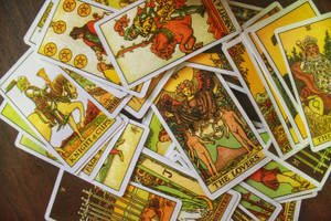 A Pile Of Tarot Cards On A Table Wallpaper